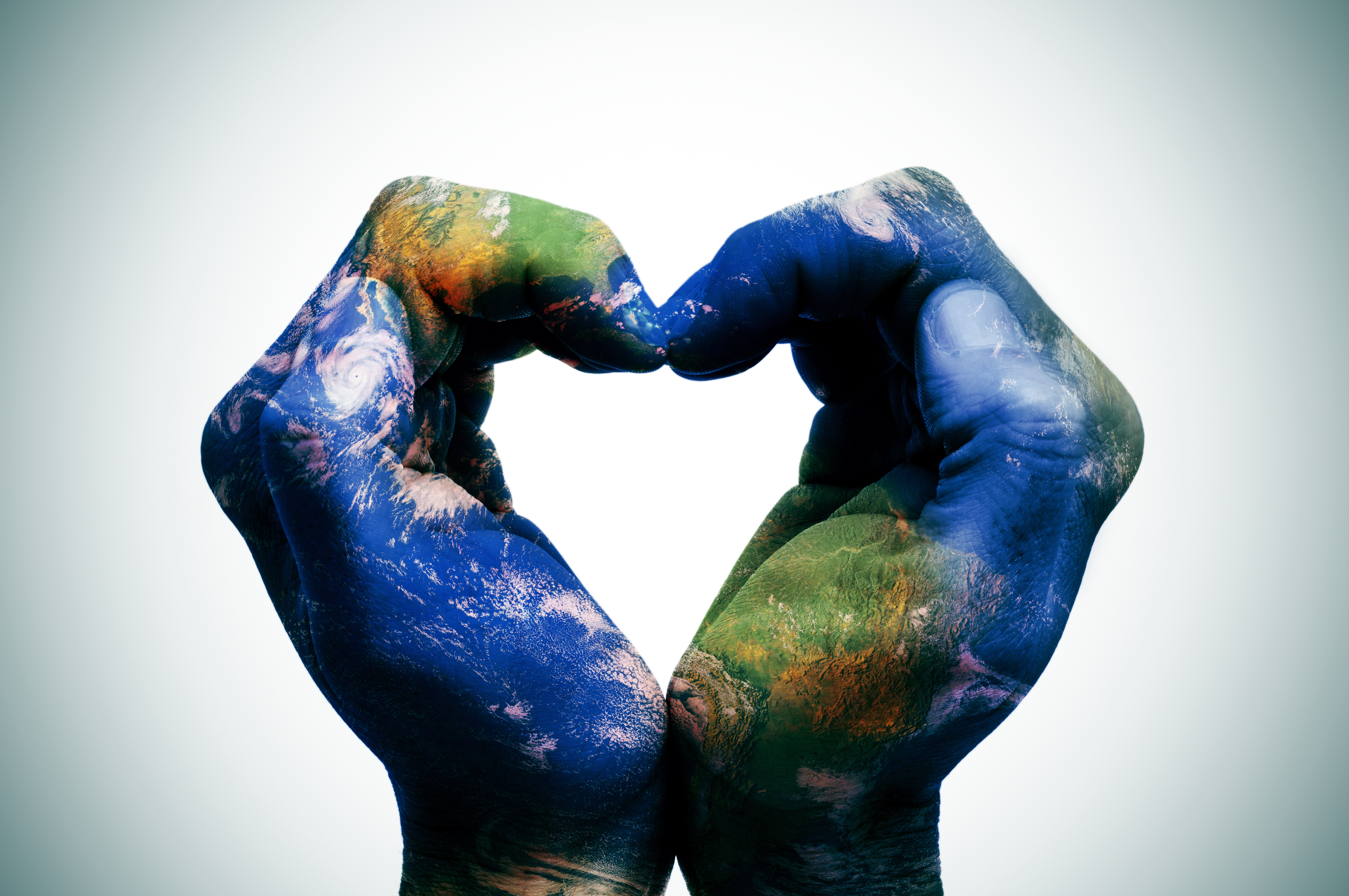 a world map in man hands forming a heart (Earth map furnished by